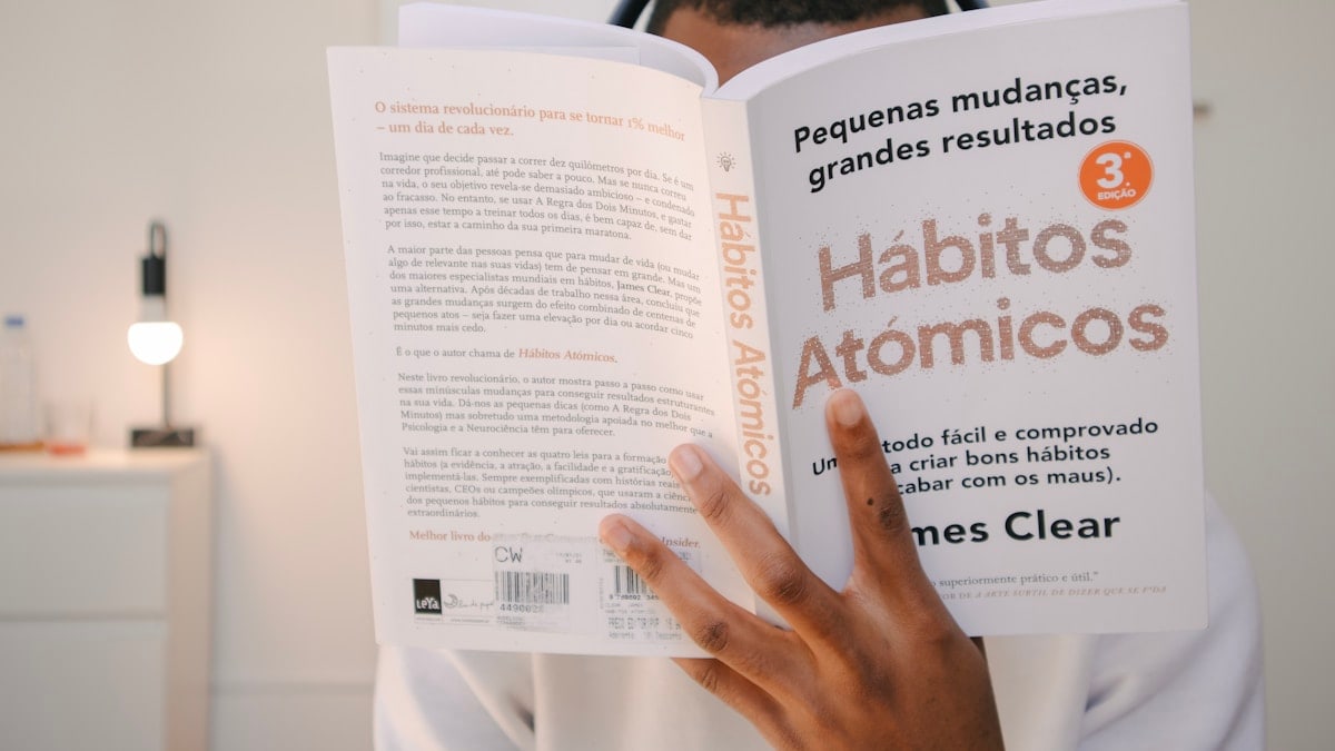 a man reading a book with headphones on his head